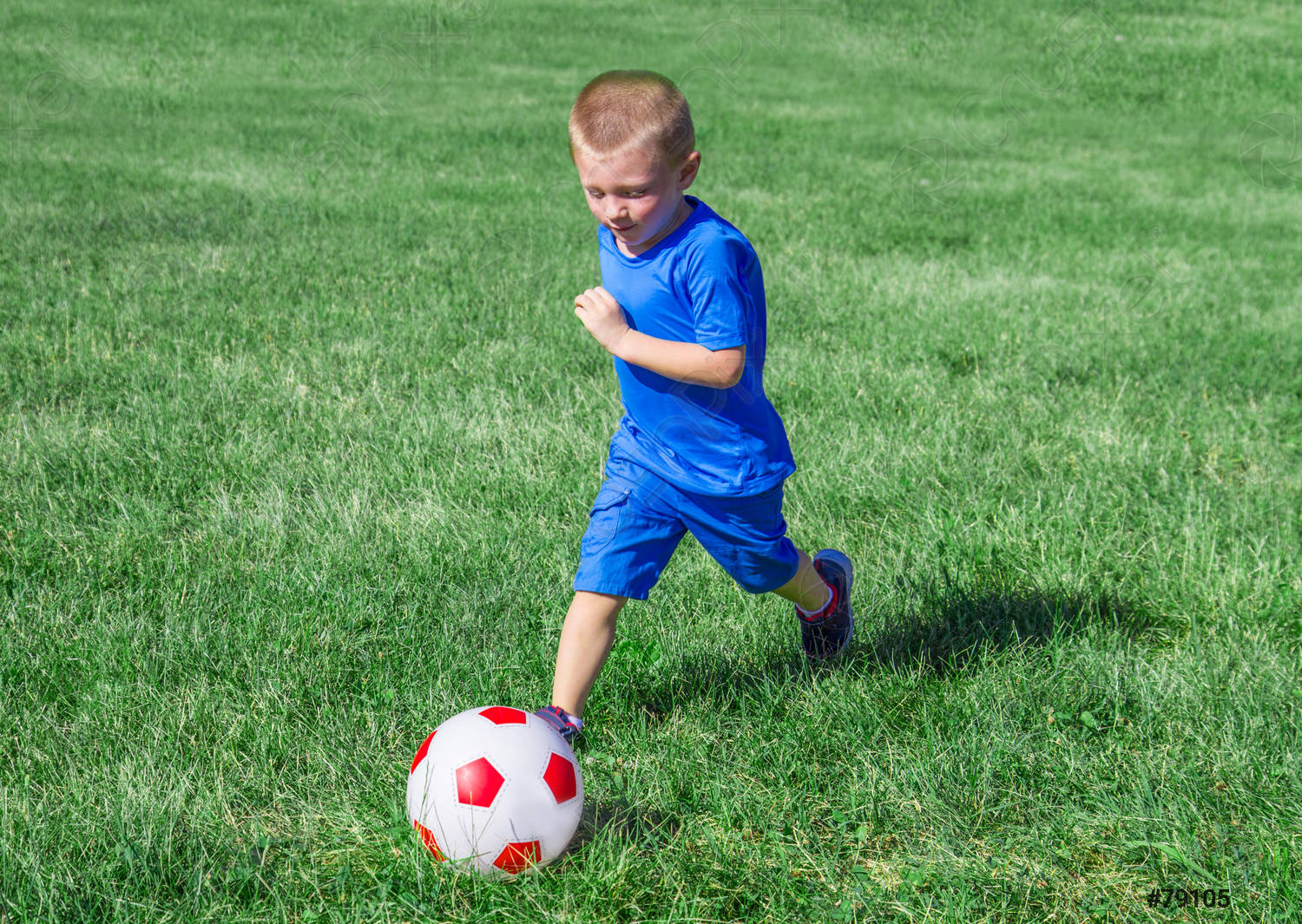 baby-playing-football-meadow-79105