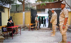 أفراد أمن أمام إحدى اللجان الانتخابية بالدوائر الموقوفة